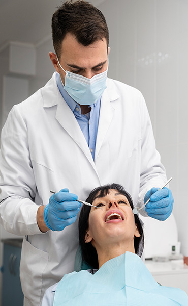 Doctor treating a person with overlapping teeth problem