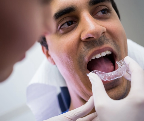 dentist-assisting-patient-wear-invisible-braces copy
